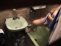 Spy camera films a juggy lady in the bathroom